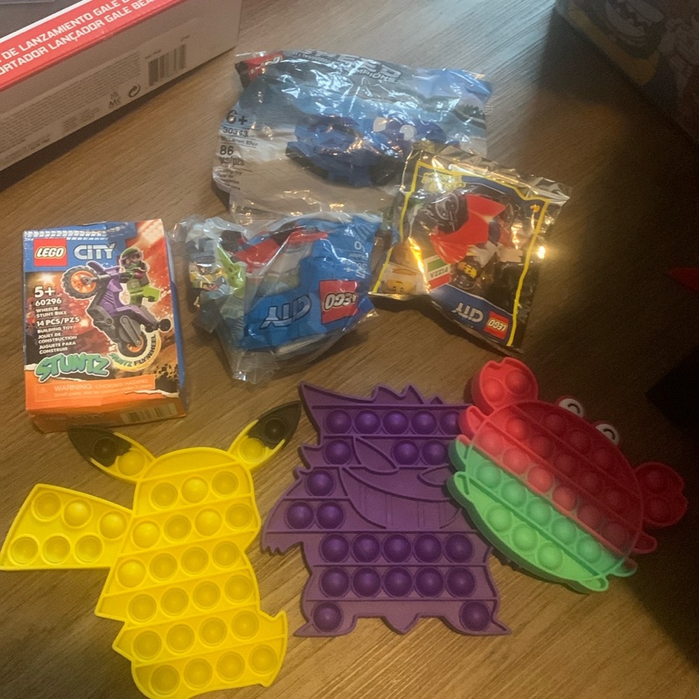 4 unopened Lego sets and 3 pop it’s